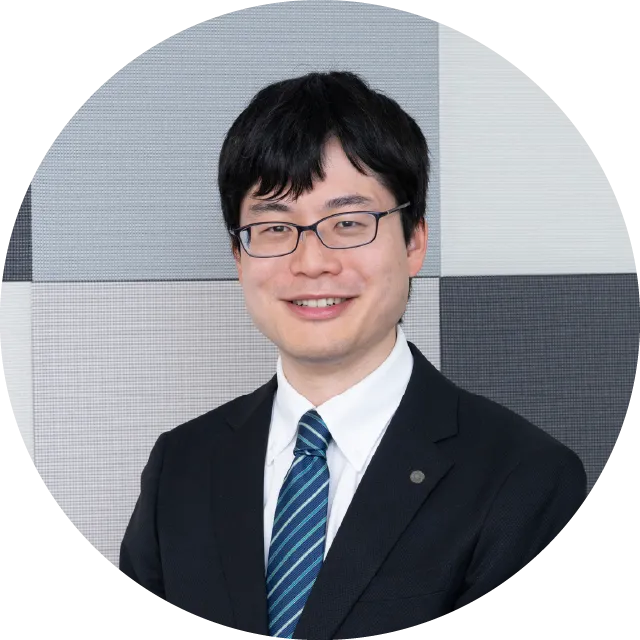 スーツ姿で微笑むS.Tさん